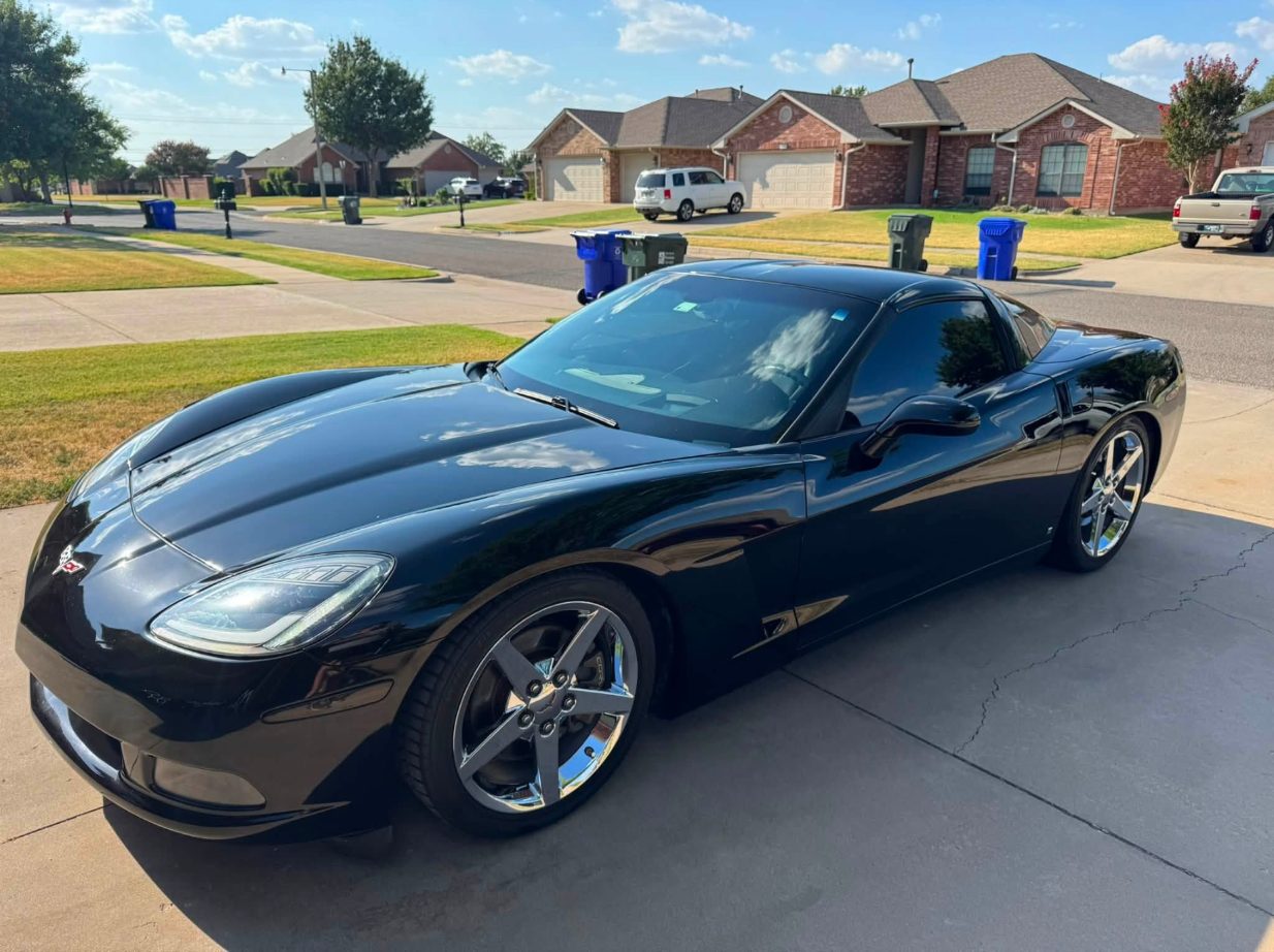 Black Corvette in the driveway after a detail