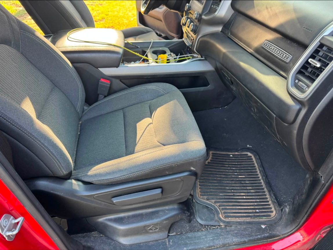 Ram 1500 passenger side before: muddy floor mats and dusty seats